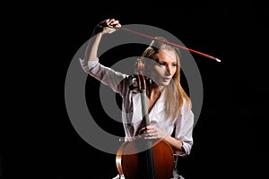 attractive girl with cello isolated over black background