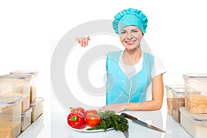 Attractive girl chef with a white plate. Isolated