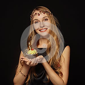 Attractive girl with a crown and cupcake