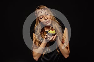 Attractive girl with a crown and cupcake