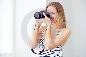 Attractive girl with digital camera