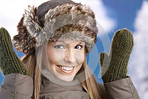 Attractive girl dressed up for winter fun smiling