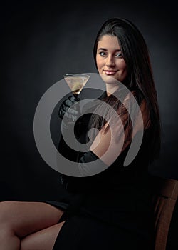 Attractive girl drinking dry martinis with green olives