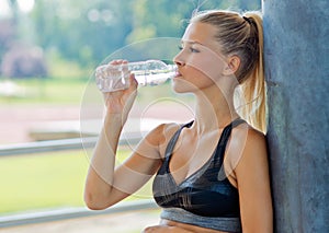 Attractive girl drinking water