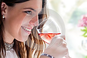 Attractive girl enjoying glass of wine.