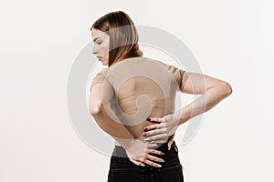 Attractive girl feel spine pain because of spinal nerves compression. Cervical spine osteochondrosis is radicular