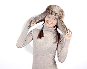 Attractive girl in a fur hat isolated on white