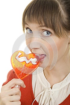 Attractive girl with heart lolly pop