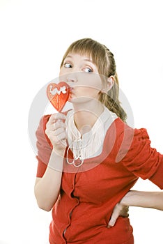 Attractive girl with heart lolly pop