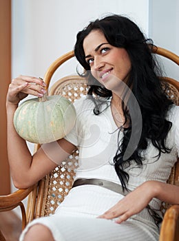 Attractive girl with holding pumpkins and smiling