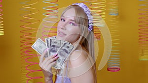 Attractive girl holds dollar banknotes in hands