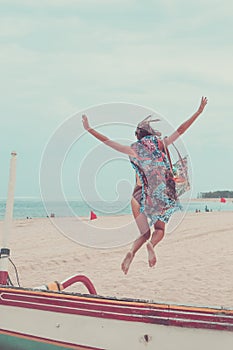 Attractive Girl Jumping on the Beach Having Fun, Summer vacation holiday Lifestyle. Happy women jumping freedom on white