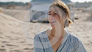 Attractive girl laughing beach at shore houses closeup. Happy beautiful woman