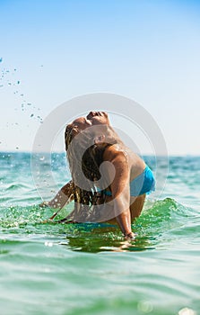 Attractive girl laying in sea