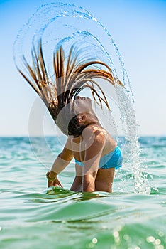 Attractive girl laying in sea