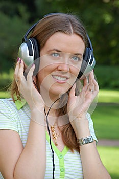 Attractive girl is listening music
