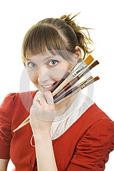 Attractive girl with paint brushes