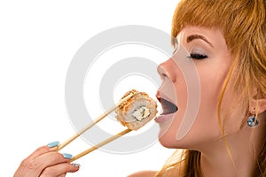 Attractive girl with pleasure eating roll