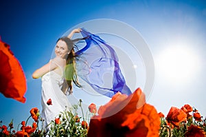 Attractive girl in the poppy field