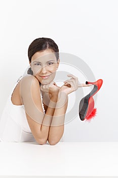 Attractive girl posing with high heel red slippers