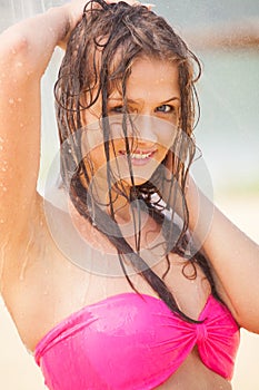 Attractive girl posing under shower