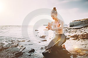 Attractive Girl Prays And Practicing Yoga on the Beach. Healthy Lifestyle, Biohacking, Fitness Concept