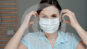 Attractive girl puts on surgical mask on her face. Cold, flu, virus, acute respiratory infections, quarantine, epidemic, irony,