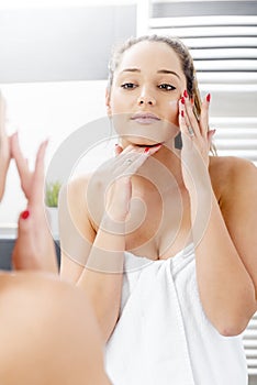 Attractive girl putting anti-aging cream