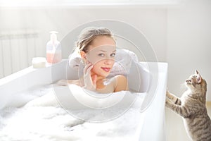 Attractive girl relaxing in bath photo