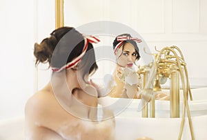 Attractive girl relaxing in the bath