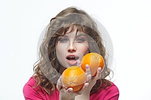 Attractive girl seductively holds oranges in her hands photo shoot in the studio on a white background