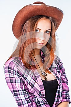 Attractive girl with straight long hair in cowboy hat