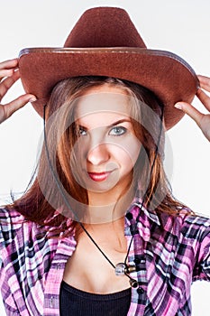 Attractive girl with straight long hair in cowboy hat