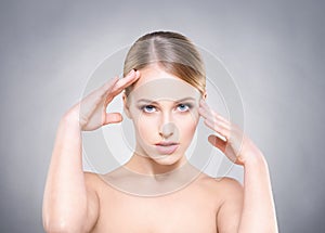 Attractive girl touching her temple and head with hands