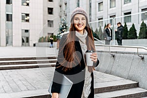 An attractive girl in urban landscape with laptop