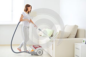 Attractive girl with vacuum cleaner