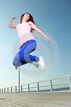 Attractive girl Young woman jumping sky