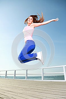 Attractive girl Young woman jumping sky