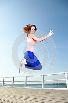 Attractive girl Young woman jumping sky