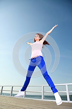 Attractive girl Young woman jumping sky