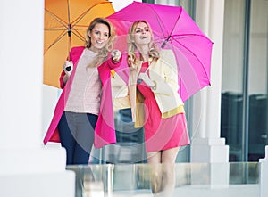 Attractive girlfriends with the colorful umbrellas