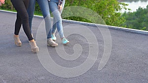 Attractive girls having fun walking on the street. Best friends spend time together and enjoy the meeting. Slow motion