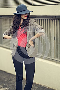 Attractive glamorous brunette wearing stylish clothes posing