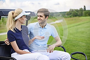 Attractive golfing couple talking