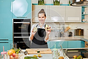 Attractive gorgeous chef with avocadoes posing to the camera