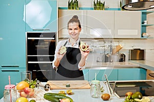 Attractive gorgeous chef with avocadoes posing to the camera