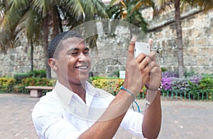 Attractive guy taking a picture with phone