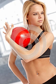 Attractive gymnast practicing with ball