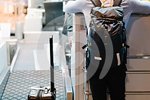 Attractive, handsome and stylish man waits for check in, weight his luggages at airline counter