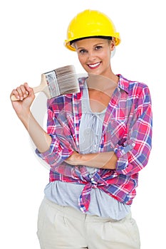 Attractive handy woman holding a brush and smiling at camera